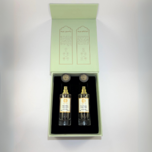 Open gift box containing two elegant AlGadhi perfume bottles, showcasing Rose Tobacco and Rose Jasmine scents