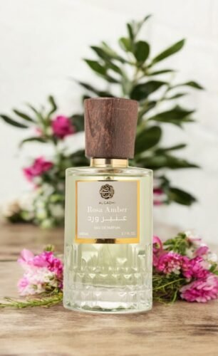 Kadi Rosa Amber Perfume - Elegant glass bottle with gold accents and floral motifs, labeled "EAU DE PARFUM 2.7 FL.OZ" (99J-11C)